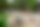 Nestschaukel im Garten des Kindergartens, im Hintergrund ein Spielturm mit Rutsche, rundherum ein Sandkasten, im Hintergrund Sitzbänke und eine Terrasse